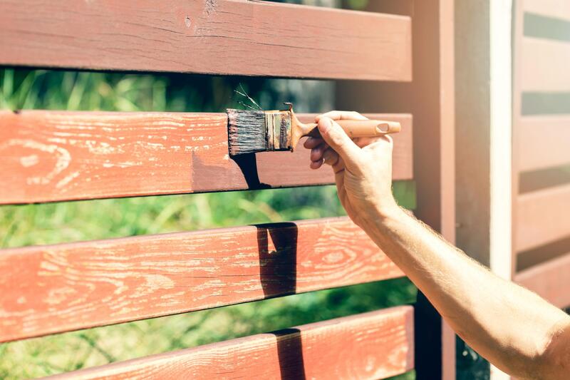 man painting a fence